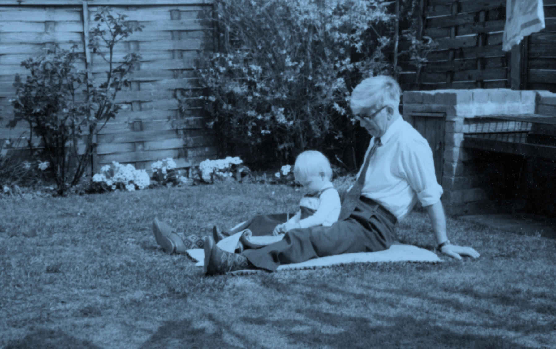Two year old Stuart Luff in the garden learning to draw with his Grandfather
